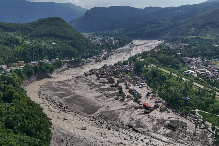 An aerial photo of houses sinking into mud.