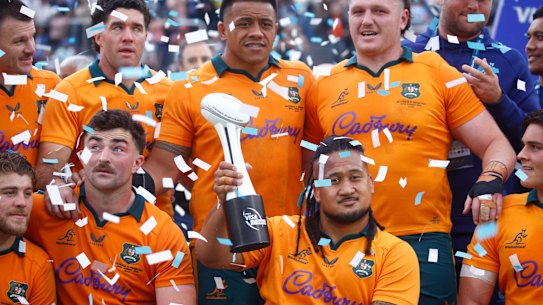 Brandon Paenga-Amosa of the Wallabies holds up the trophy.