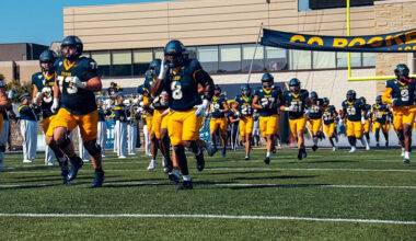 Toledo football players run onto the field before the game.