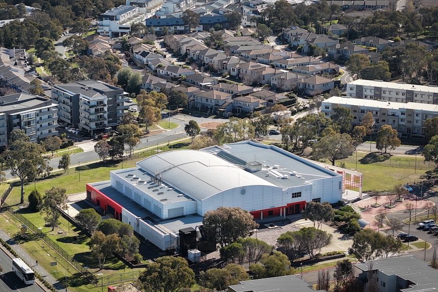 An aerial view of a data centre surrounded by apartments and townhouses.