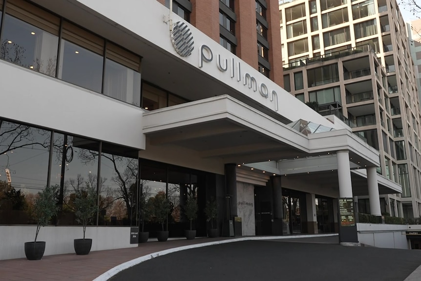 A driveway winds past a multi-storey building with a sign that says "Pullman".