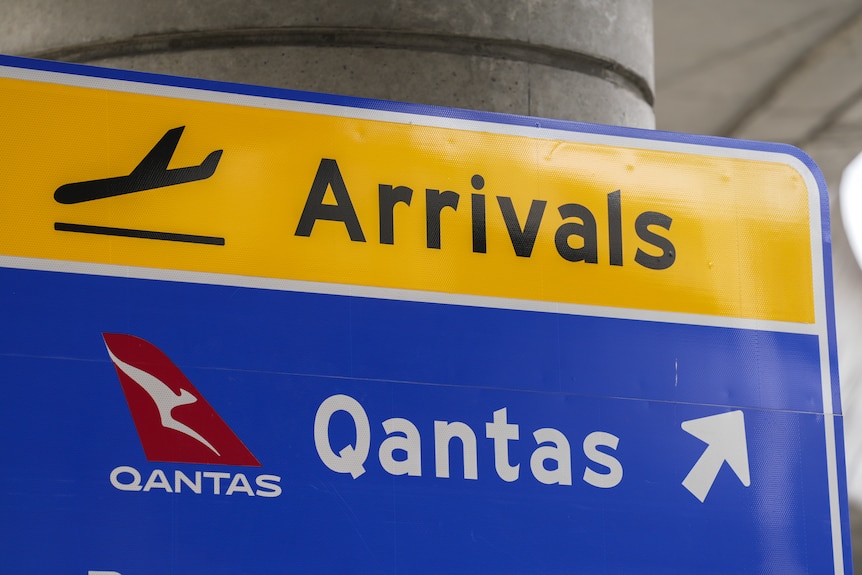 A sign indicating airport arrivals for Qantas passengers at Sydney Airport.
