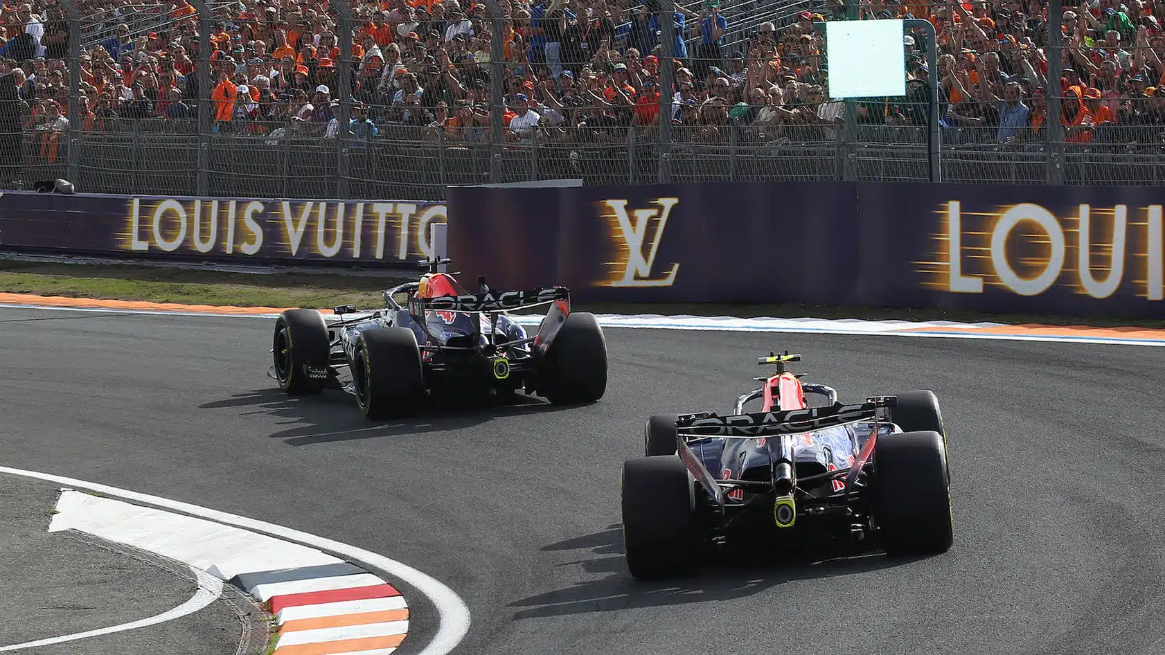 Max Verstappen (Red Bull-Ford) with big crowd and team mate Liam Lawson seen from behind in practice for the 2026 Dutch Grand Prix