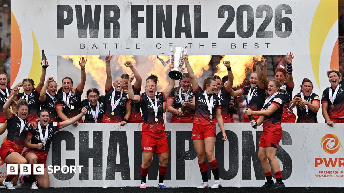 Marlie Packer and Zoe Harrison of Saracens lift the PWR trophy in celebration following the Premiership Women's Rugby Final match between Saracens Women and Ealing Trailfinders at Twickenham Stoop