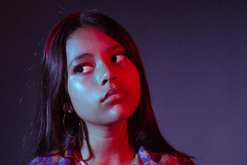 young sydney singer songwriter Niko Karolia looks sideways in a press shot for her debut single sana
