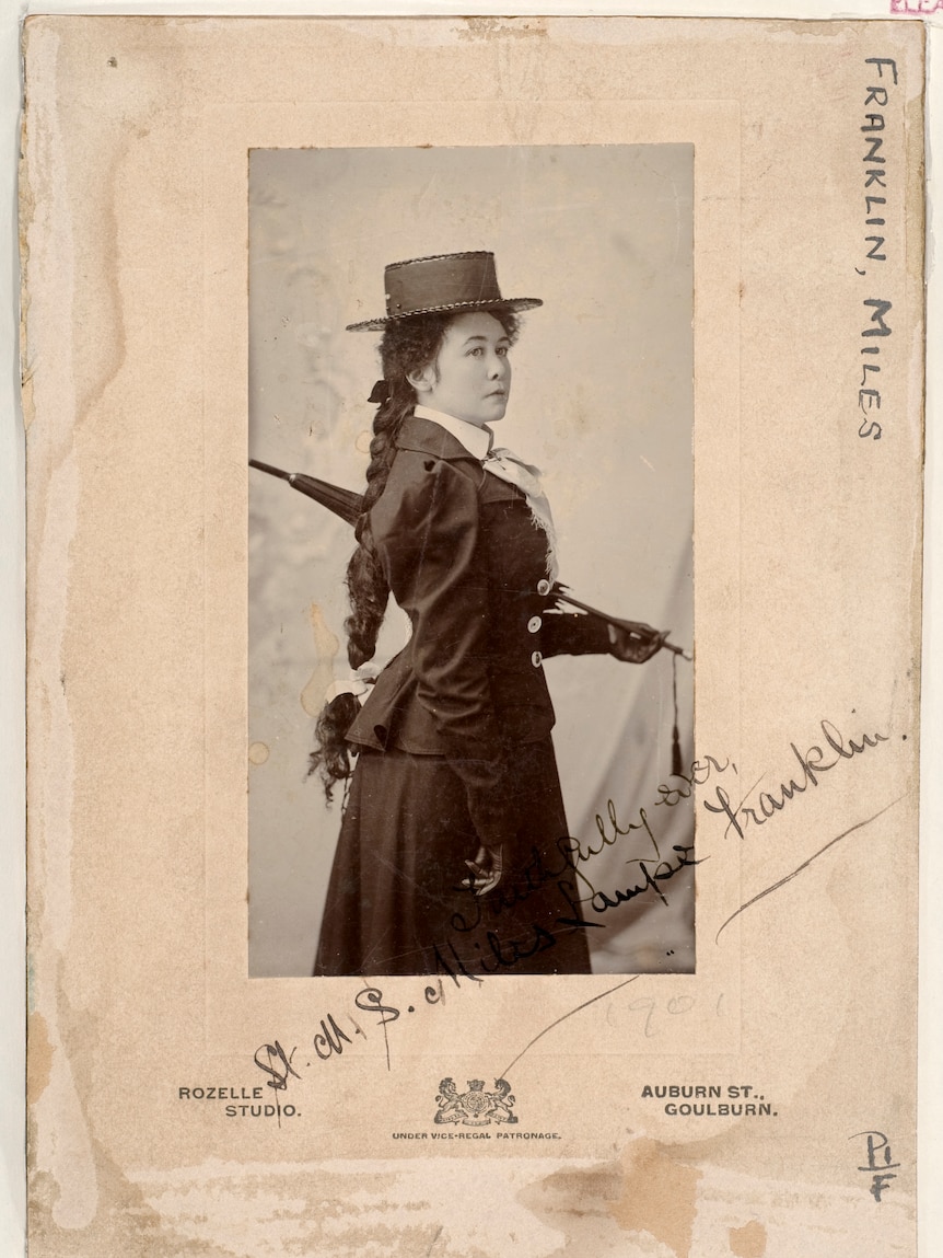 A black and white photo of Stella Miles Franklin in the early 1900s, long curly hair down her back.