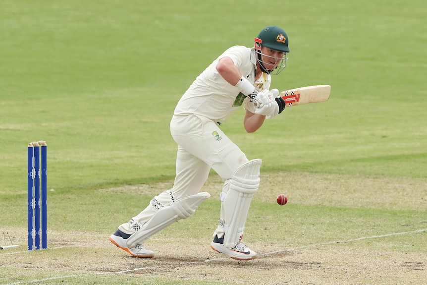 Batter Matt Renshaw watches a ball off his bat during the Prime Minister's XI cricket game against Pakistan.