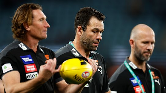 James Hird and Dean Solomon speak with then Giants interim coach Mark McVeigh during the 2022 season.