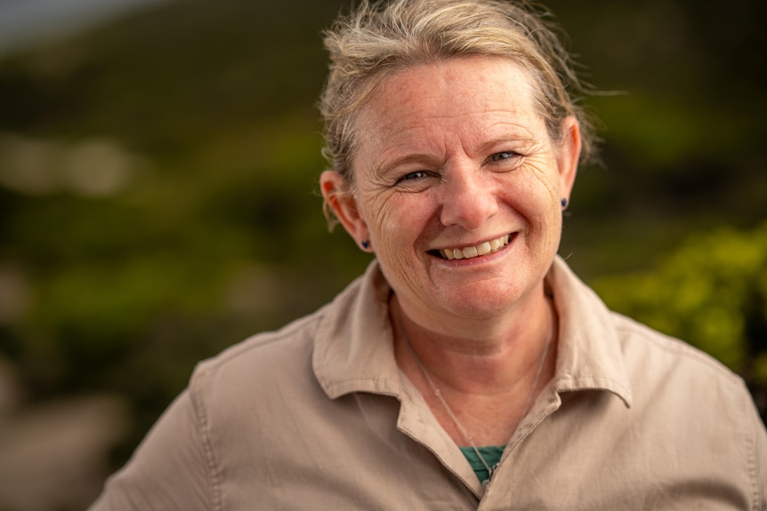 A woman smiles at the camera