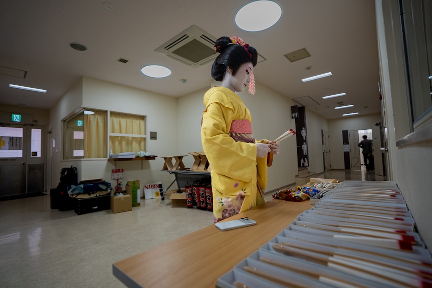 A woman setting up fans.