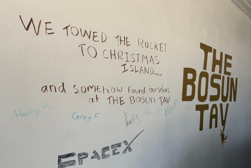 A close of sign reading reading: we towed the rocket to Christmas Isalnd