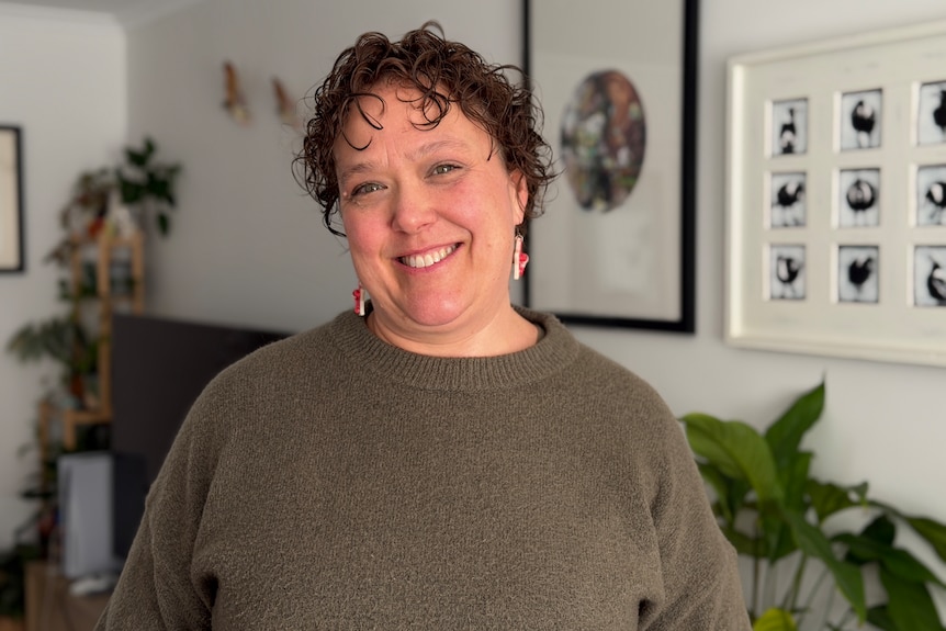 A woman in arts smiles.