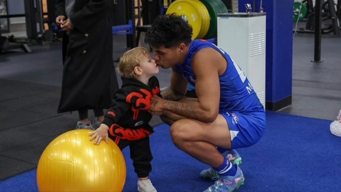 North Melbourne forward Paul Curtis and his son Elliot.