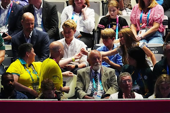 Australian chef de mission gives Princess Charlotte a pin.