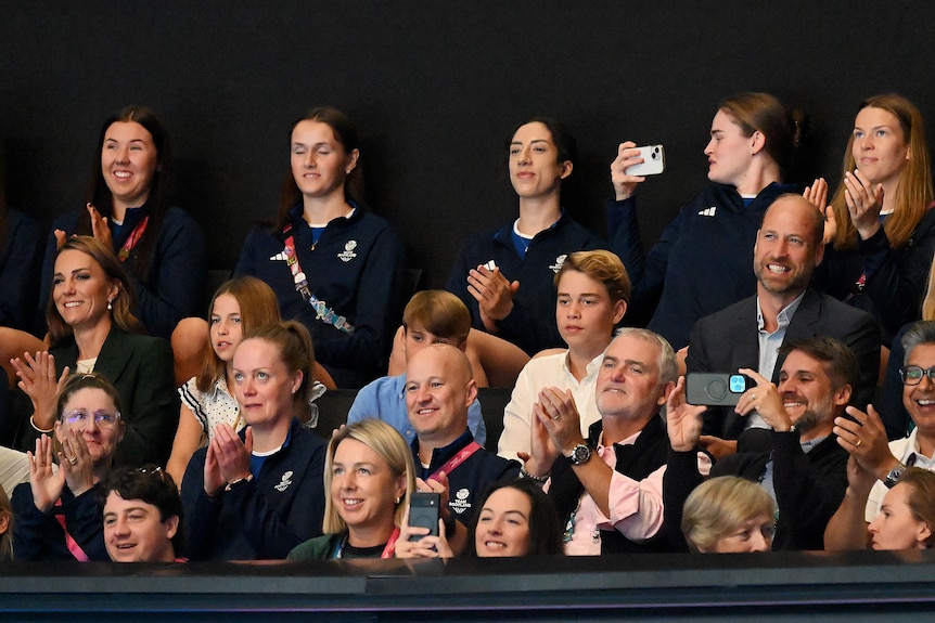 British royal family sitting in a stadium watching the netball.