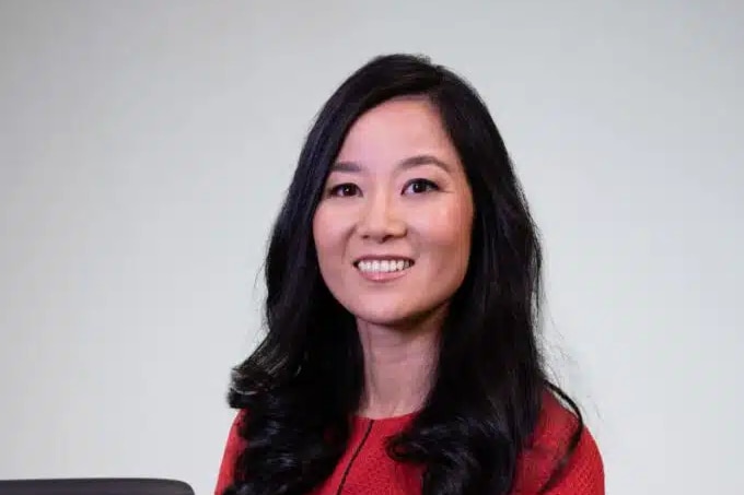 An Asian woman in a red dress with long black hair.