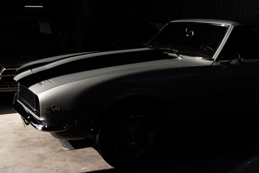 An image of a grey fast car in a garage.