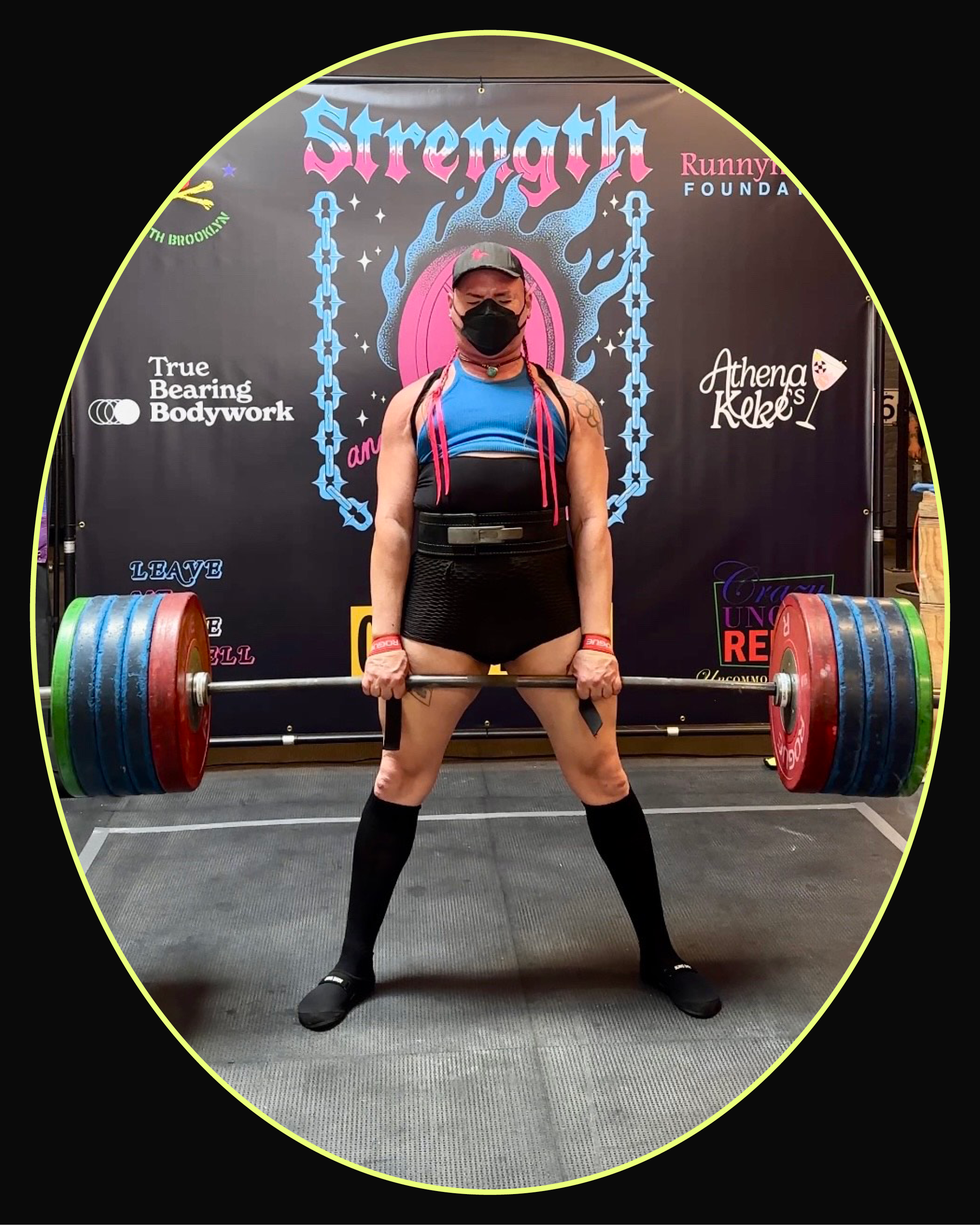 Athlete performing a deadlift in a gym with a barbell and a mask, showcasing strength and focus.