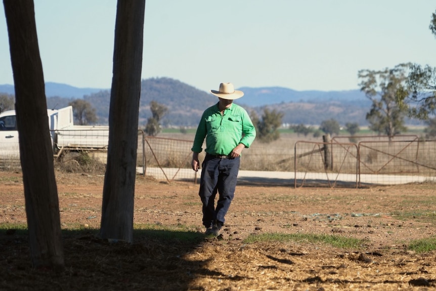 Farmer Greg Finlay walking through his empty hay shed