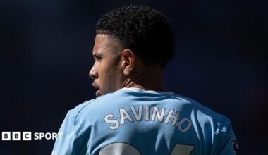 The back of Savino's shirt with his head turned to the side