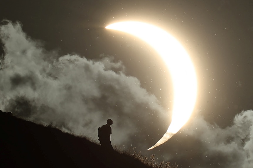 The partially eclipsed Sun shines against what looks like a night sky.
