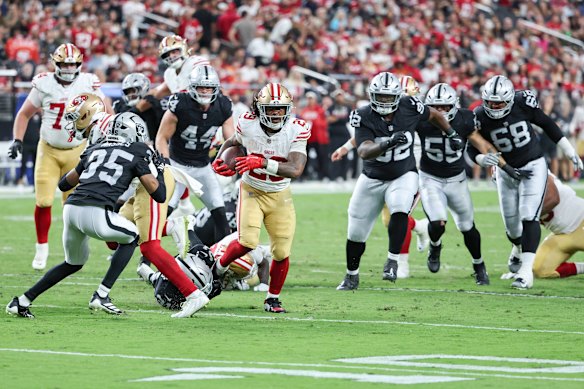 San Francisco’s Jordan James, with the ball, tries to get past the Las Vegas Raiders in a pre-season game on Thursday.