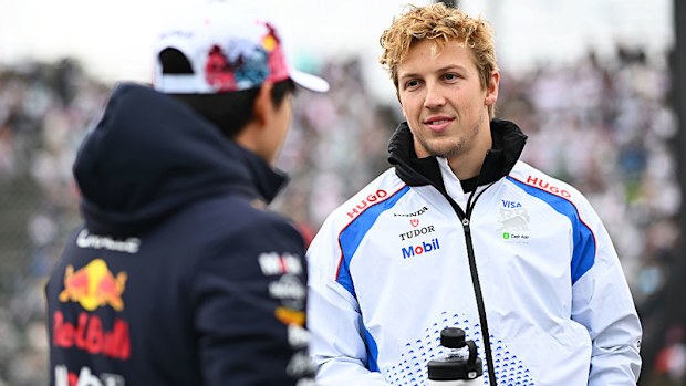 Yuki Tsunoda of Oracle Red Bull Racing and Liam Lawson of Visa Cash App Racing Bulls talk on the drivers parade prior to the F1 Grand Prix of Japan.