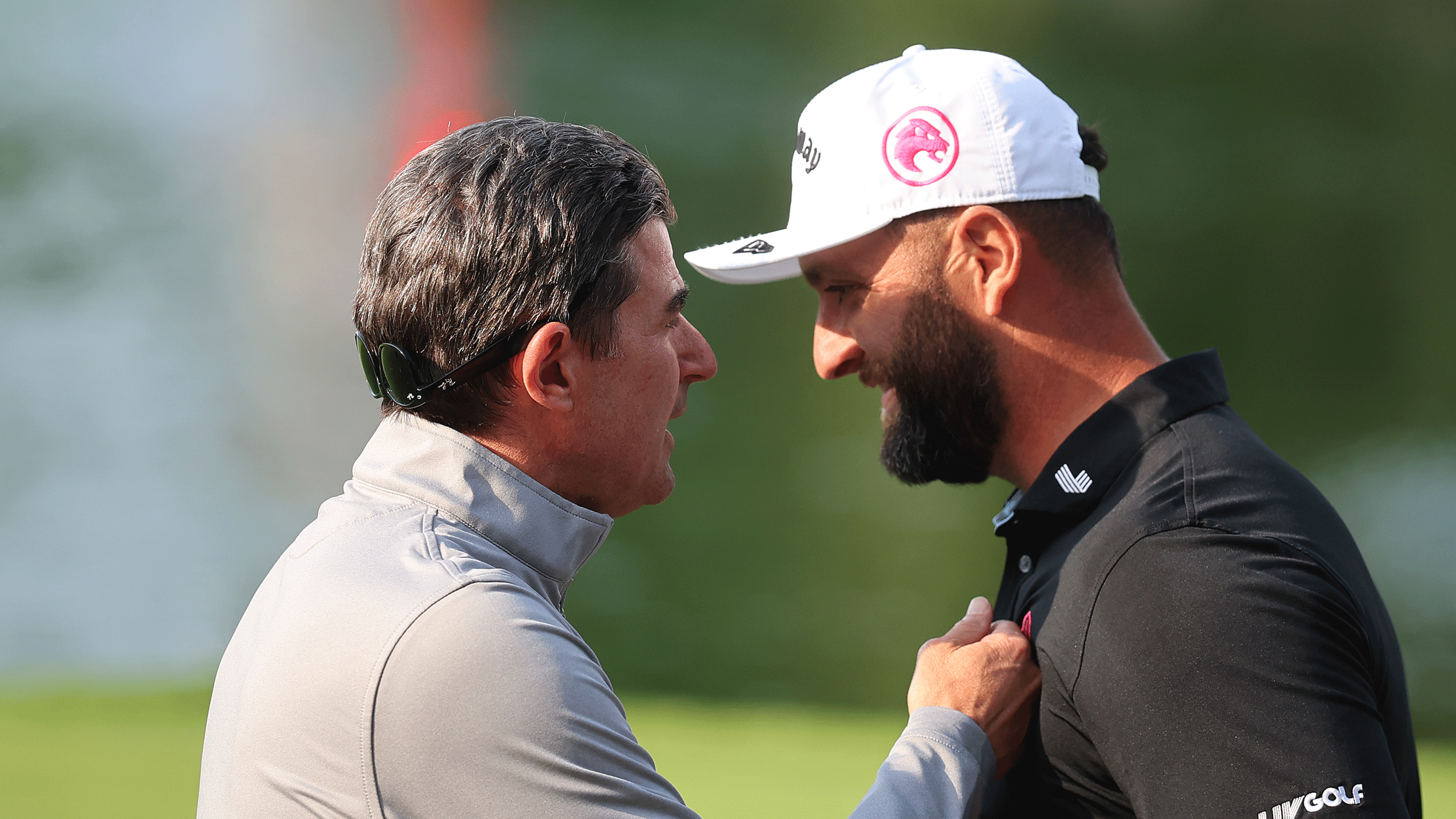 Scott O'Neil speaks to Jon Rahm in close proximity after his LIV Golf Mexico City win