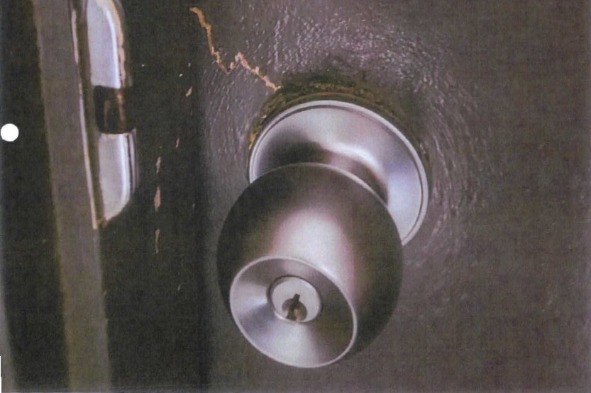 A scan of a printed pgoto of a broken doorhandle