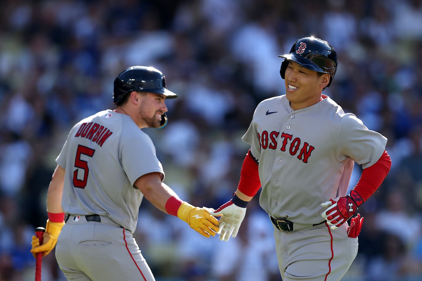Masataka Yoshida (right) is congratulated by Caleb Durbin after his solo home run in the third inning Sunday.