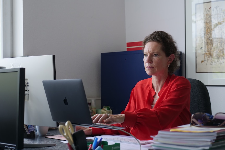 A woman in a red shirt.