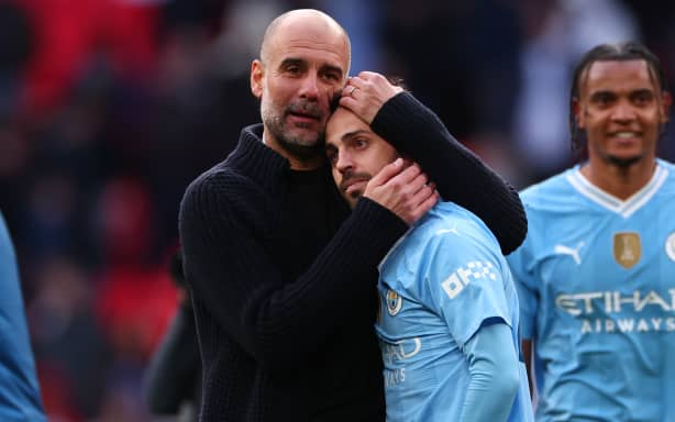 Manchester City manager Pep Guardiola (L) and Bernardo Silva.