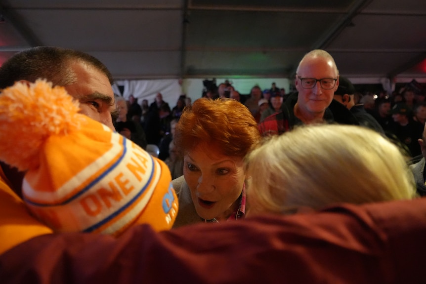 Pauling Hanson interacting with a baby in a One Nation beanie.