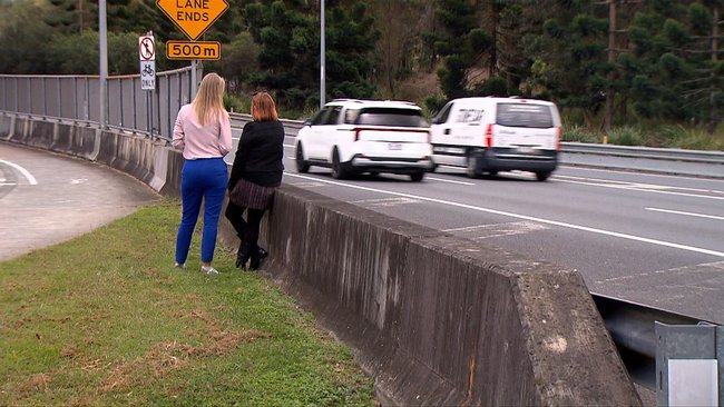 The woman was left alone beside speeding traffic.