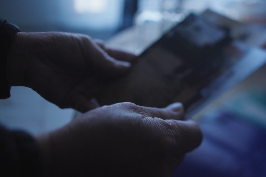 Man looking at photos