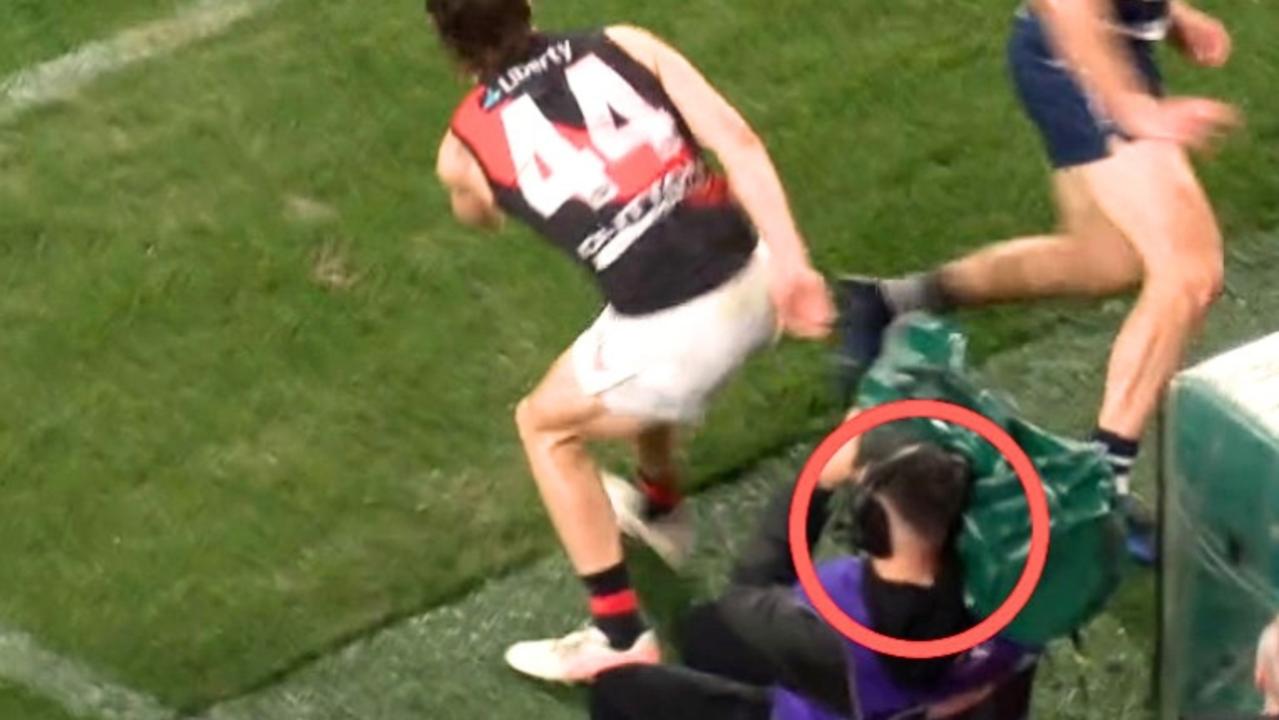 AFL cameraman wiped out in shock moment as Essendon star forced to apologise during Geelong loss