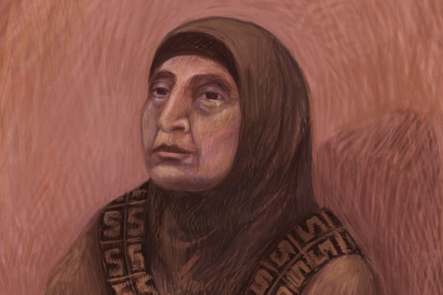 A woman wearing a brown hijab sits in court.