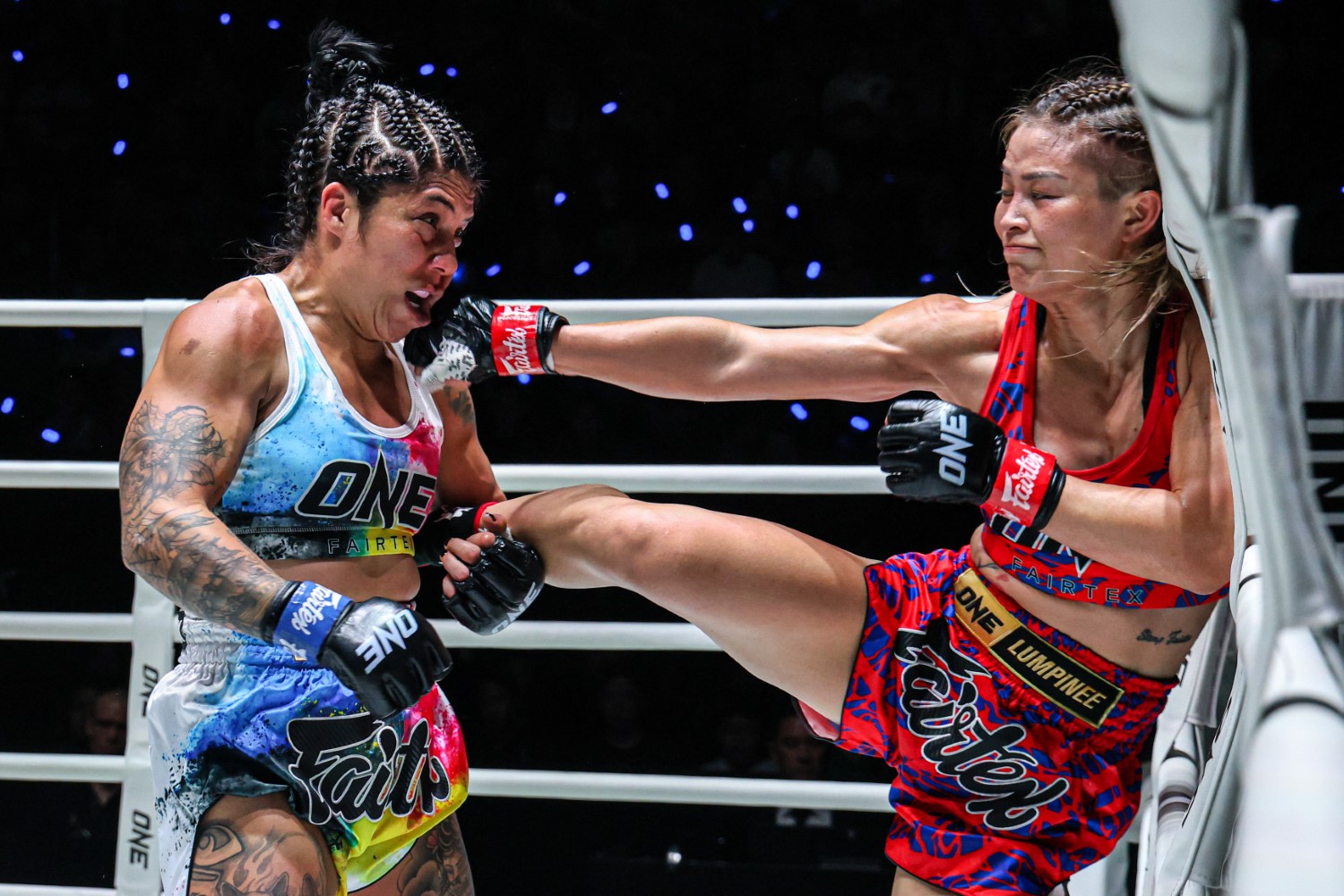 Stamp Fairtex (right) lands a body kick on Cynthia Flores during their atomweight Muay Thai fight