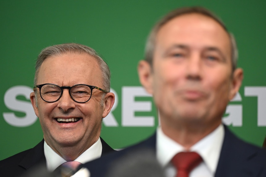 Close up of two men at a press conference