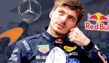 Max Verstappen looks up surrounded by Mercedes, McLaren and Red Bull logos