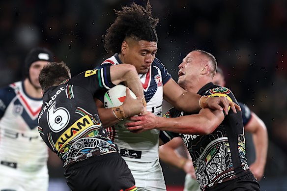 Roosters prop Naufahu Whyte makes a typically strong charge.
