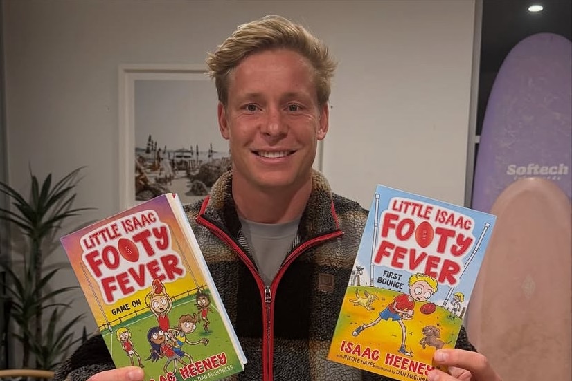 Isaac Heeney holds two books