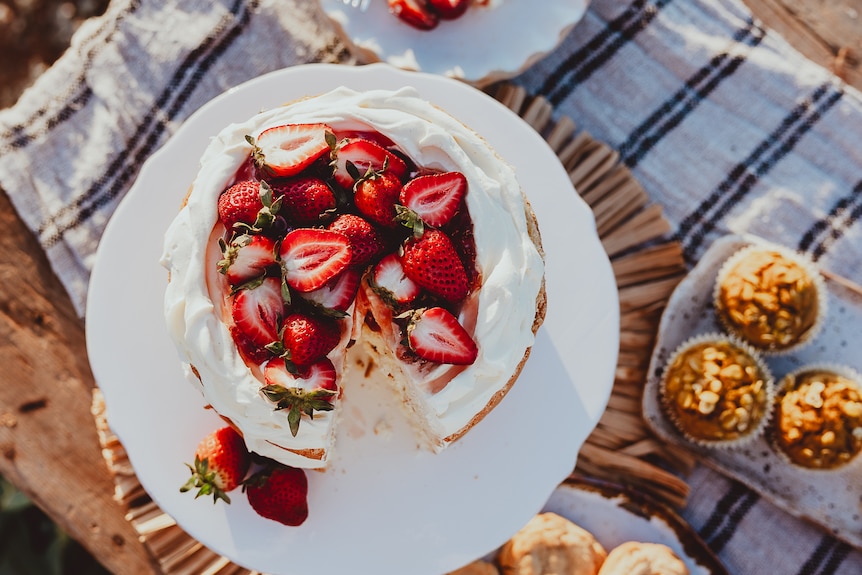 A food spread with cake and strawberries