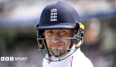 Joe Root smiles under his dark blue helmet