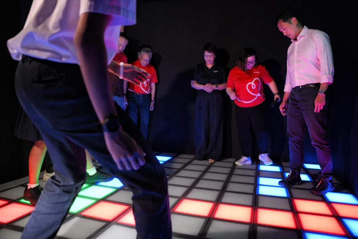 Minister for Health Ong Ye Kung (far right) plays “The Floor is Lava” at the Mind Cove. The immersive, sensory-based learning space allows youths to step into guided scenarios that mirror real digital situations, where they can practise emotional regulation.
