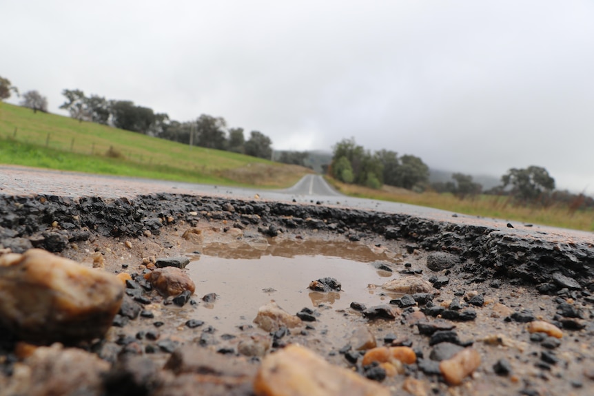 A close up of a pothole.