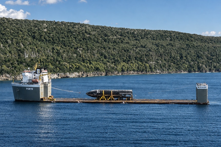 A wide shot of a rocket on a boat