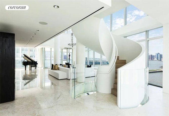 A spiral staircase connects all three floors.