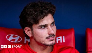 Julian Alvarez pictured looking to the side while sat on the bench during Atletico Madrid's match against Villarreal in August.