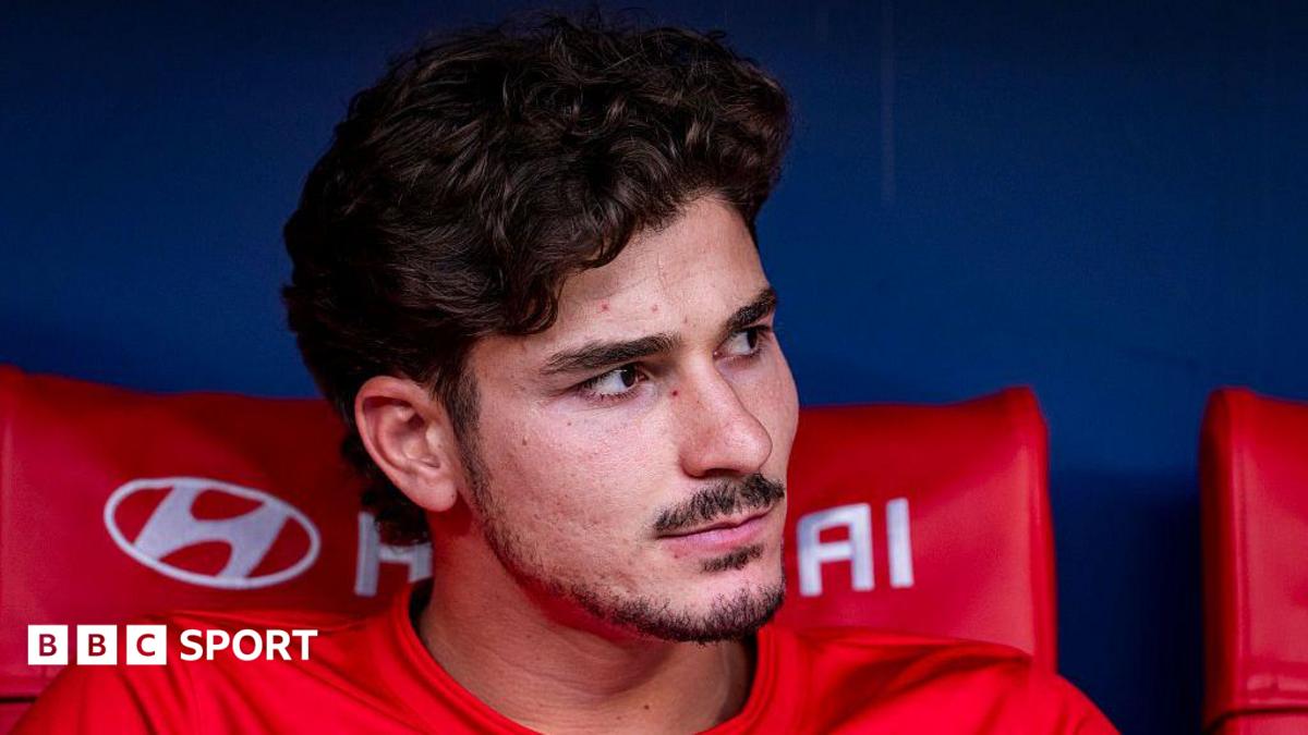 Julian Alvarez pictured looking to the side while sat on the bench during Atletico Madrid's match against Villarreal in August.